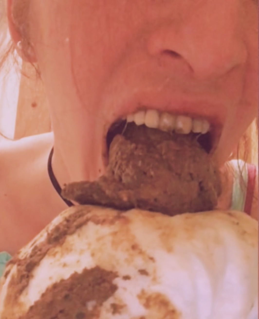 Nalina Wonders taking a big bite at her fresh made poop, showing her teeth.